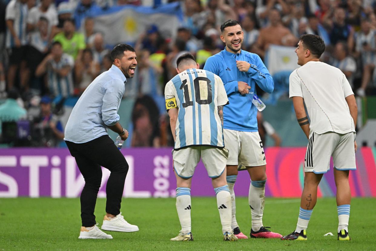Argentina's forward #10 Lionel Messi, Argentina's midfielder #05 Leandro Paredes (2-R), Argentina's forward #21 Paulo Dybala (R) celebrate with ex-player Sergio Aguero after qualifying to the next round after defeating Netherlands in the penalty shoot-out of the Qatar 2022 World Cup quarter-final football match between Netherlands and Argentina at Lusail Stadium, north of Doha, on December 9, 2022. (Photo by Alberto PIZZOLI / AFP) (Photo by ALBERTO PIZZOLI/AFP via Getty Images)