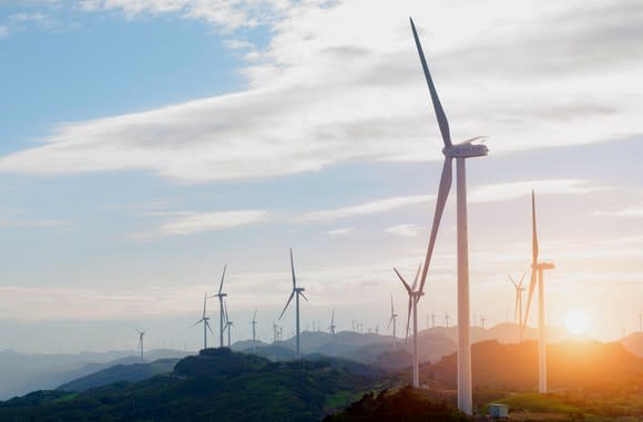 Wind turbines dotting a mountain landscape.