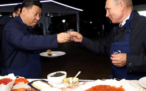 Xi Jinping and Vladimir Putin toast on the sidelines of the eastern economic forum in Vladivostok - Credit: Sergei Bobylev/TASS/Reuters