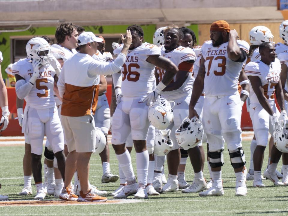 Texas coach Steve Sarkisian huddles with his team after its spring game.
