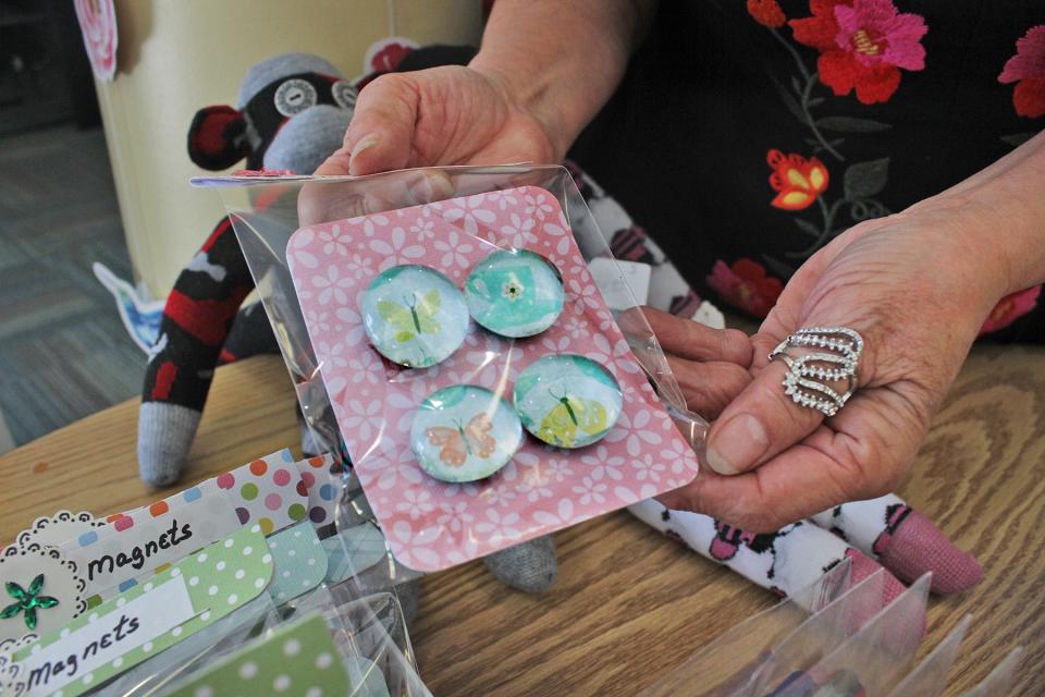 Jackie Jimenez holds some of the magnets she and her sisters have created that will be offered for sale at the Small Business Expo 10 a.m. to 4 p.m. May 4 at Pueblo Community College's student center.