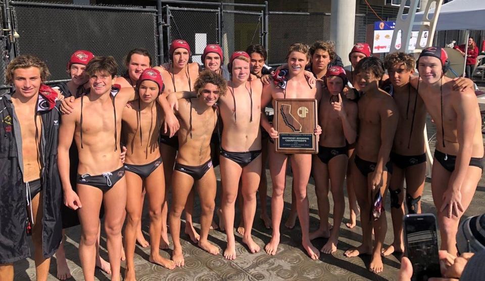 The Oaks Christian boys water polo team poses with the championship plaque after winning the CIF-State SoCal Regional Division II title.