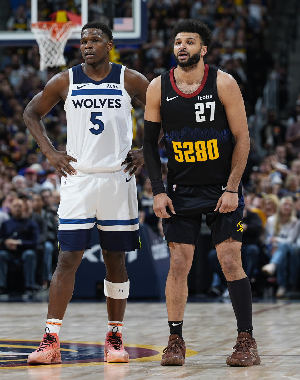 Minnesota Timberwolves guard Anthony Edwards, left, and Denver Nuggets guard Jamal Murray wait for play to resume during the second half of Game 5 of an NBA basketball second-round playoff series Tuesday, May 14, 2024, in Denver (AP Photo/David Zalubowski)