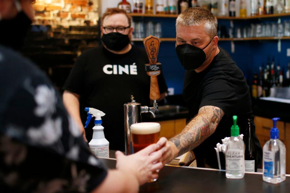 Ciné's Johnny Ray serves up a beer to a patron before the theater reopened to the public on Thursday, May 27, 2021. The theater was closed for more than a year due to the COVID-19 pandemic.