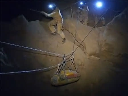 Rescuers help transport injured researcher Johann Westhauser inside the Riesending cave in Untersberg, south of Munich in this still image taken from video from a camera mounted on the helmet of a rescuer released by Bavaria's mountain rescue team "Bergwacht Bayern" on June 16, 2014. REUTERS/Bergwacht Bayern/Handout via Reuters TV