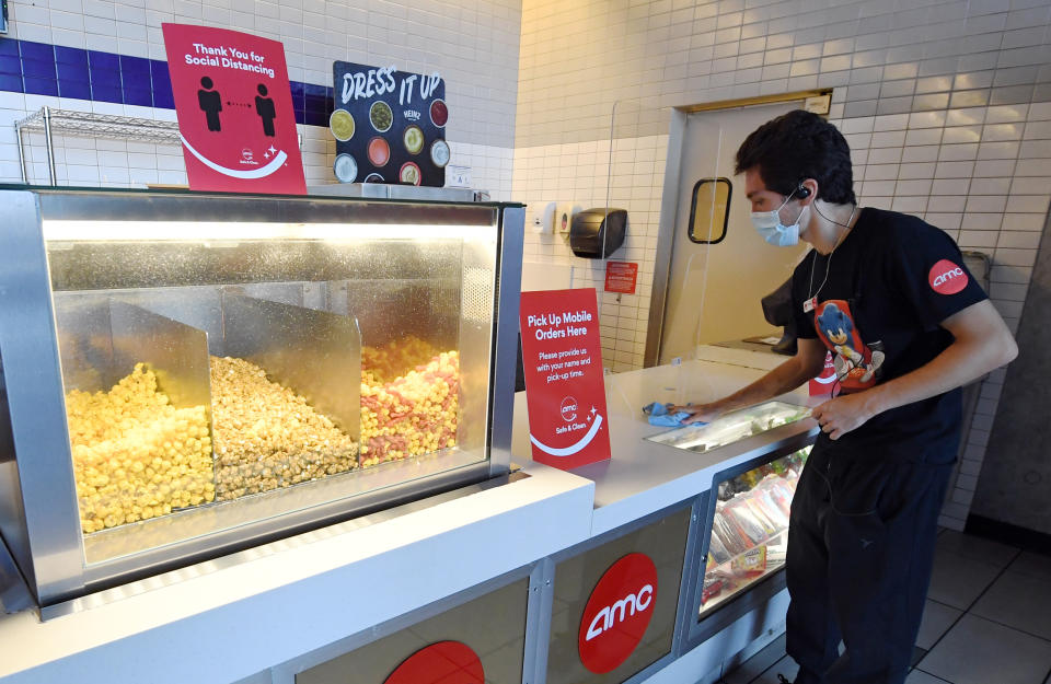 LAS VEGAS, NEVADA - AUGUST 20: Joey Walsh sanitizes the concession stand at AMC Town Square 18 on August 20, 2020 in Las Vegas, Nevada. 