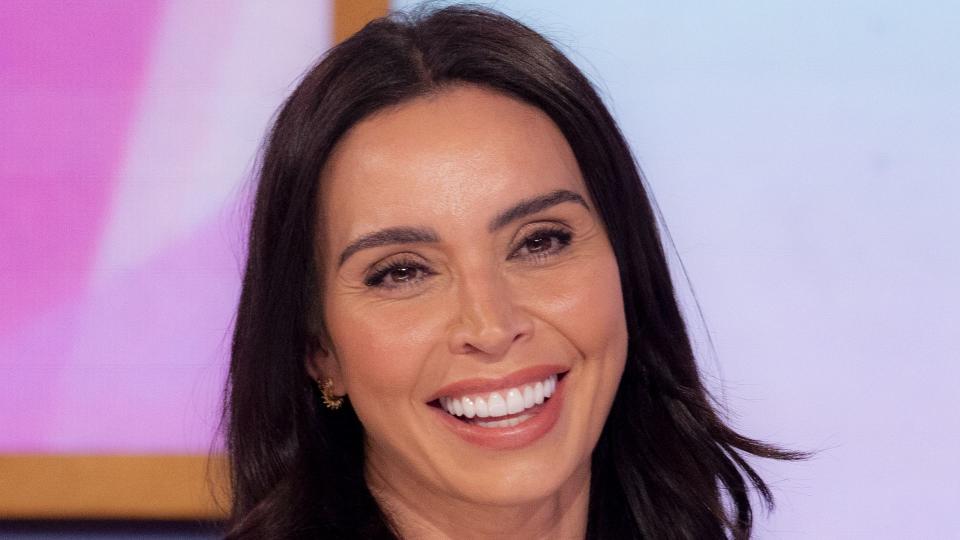 woman in purple shirt smiling 