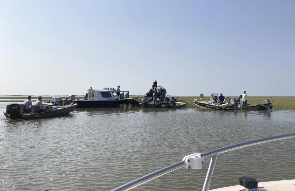 Volunteers on boats gather on Thursday, April 29, 2021, on the water along the Louisiana coast before setting out to look for survivors of the Seacor Power, a lift boat that capsized on April 13. Volunteers have been searching by air and boat for any sign of the seven people still missing. (AP Photo/Rebecca Santana)