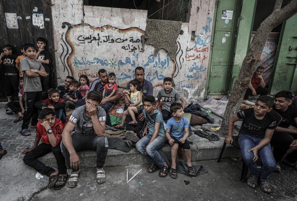 Palestinian Al Deyri family's children are seen at street after their home demolished by Israeli army's airstrikes in Gaza City, Gaza on May 17, 2021.