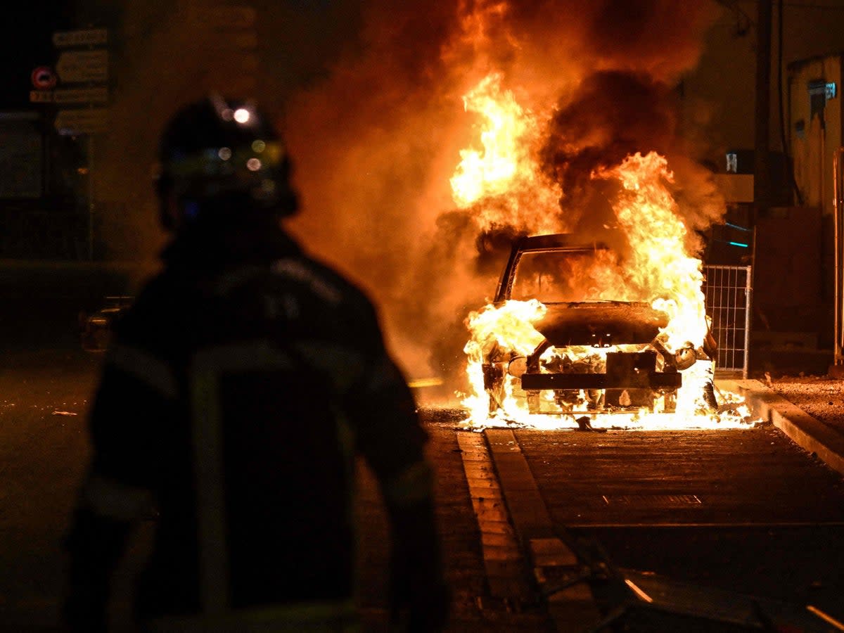 A flaming car during the clashes overnight   (AFP via Getty Images)