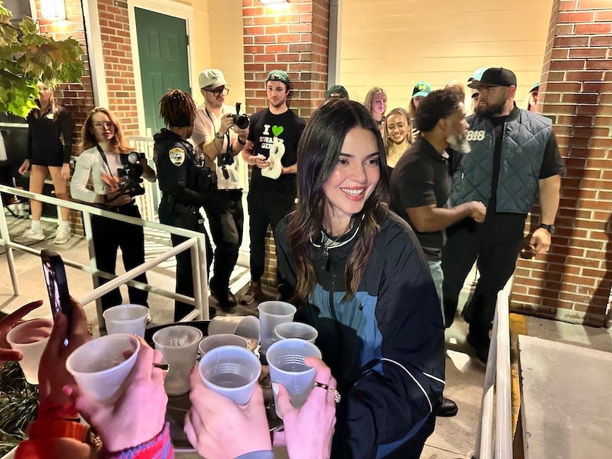 Model Kendall Jenner gives out drink Wednesday night at The Swamp Restaurant in Gainesville.