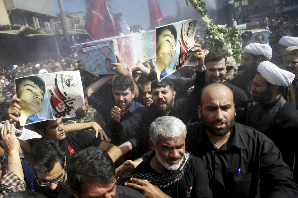 Mourners carry a casket during a mass funeral for those who died in a terror attack on a military parade in the southwestern city of Ahvaz, that killed 25 people attend a mass funeral ceremony, in Ahvaz, Iran, Monday, Sept. 24, 2018. Thousands of mourners gathered at the Sarallah Mosque on Ahvaz's Taleghani junction, carrying caskets in the sweltering heat. (AP Photo/Ebrahim Noroozi)