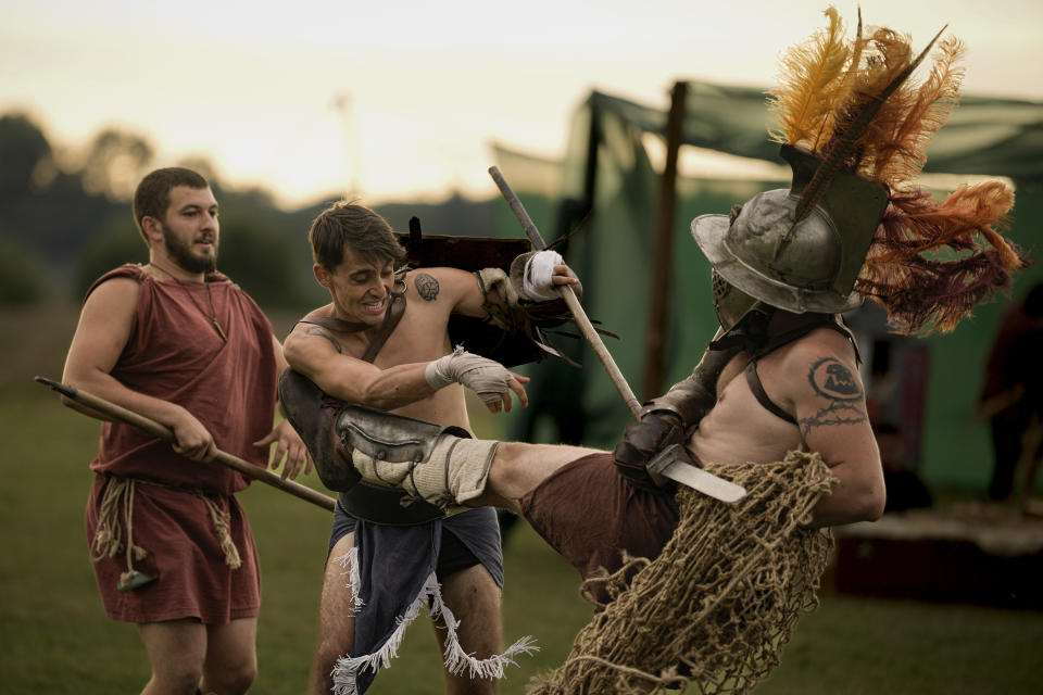 Participants in the Romula Fest reenact Roman Empire era gladiator fights in the village of Resca, Romania, Saturday, Sept. 3, 2022. (AP Photo/Andreea Alexandru)