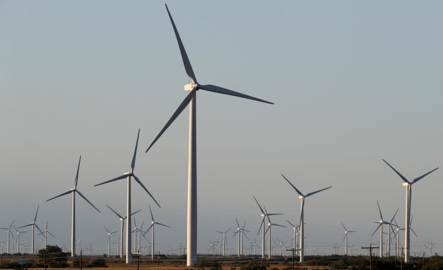 <em>Wind turbines are seen on a rural road off of Interstate 20, Wednesday, July 29, 2020, near Sweetwater, Texas.</em>