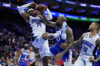 Orlando Magic's Gary Harris (14) pulls in a rebound against Philadelphia 76ers' P.J. Tucker (17) during the first half of an NBA basketball game, Wednesday, Feb. 1, 2023, in Philadelphia. (AP Photo/Matt Slocum)