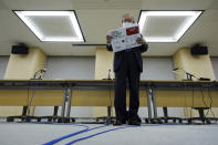 Lawyer Kenji Utsunomiya, a representative of an anti-Olympics group, arranges boards showing the current figure of online petition during a press conference after submitting a petition to the Tokyo government calling for the cancellation of the Tokyo 2020 Olympics and Paralympics. An online petition calling for the Tokyo Olympics to be cancelled has been submitted to the Tokyo government with over 350,000 signatures on Friday morning. The rollout of the petition comes with Tokyo, Osaka and several other areas under a state of emergency with coronavirus infections rising - particularly new variants. (AP Photo/Eugene Hoshiko)