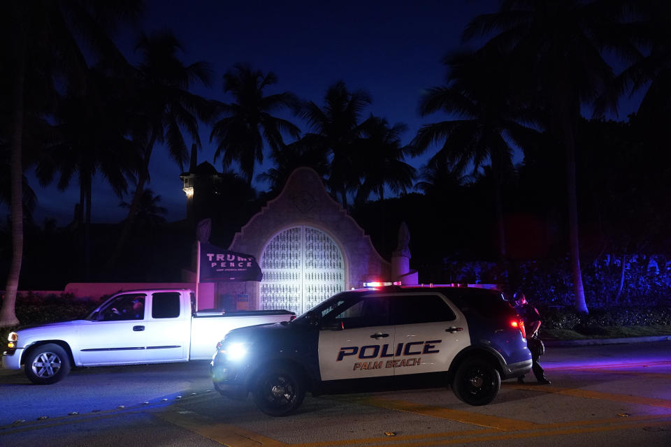 A supporter of former President Donald Trump drives past his Mar-a-Lago estate, Monday, Aug. 8, 2022, in Palm Beach, Fla. Trump said in a lengthy statement that the FBI was conducting a search of his Mar-a-Lago estate and asserted that agents had broken open a safe. (AP Photo/Wilfredo Lee)