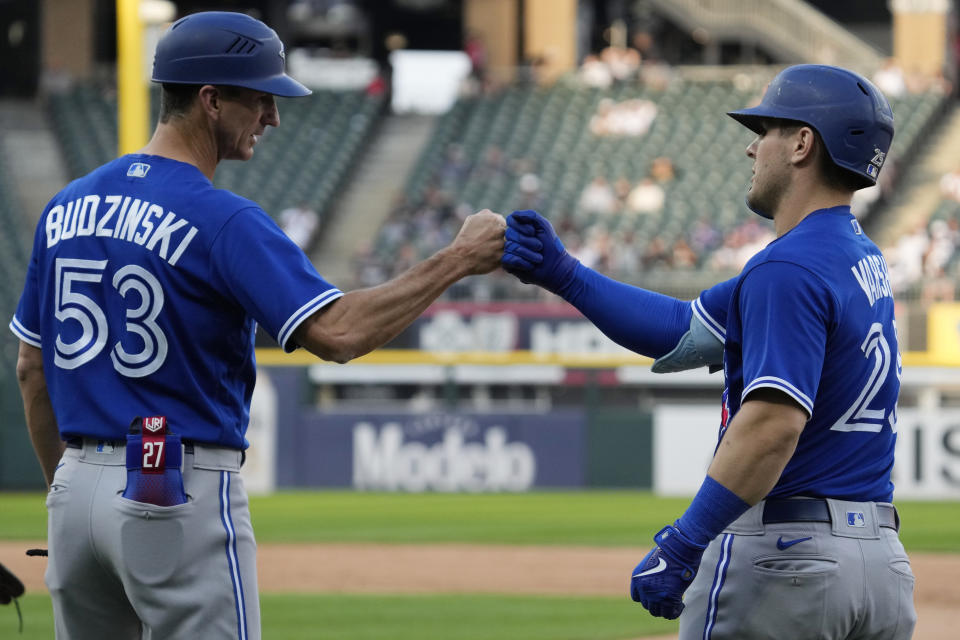 Toronto Blue Jays' Daulton Varsho, right, celebrates with first base coach Mark Budzinski after hitting an RBI single against the Chicago White Sox during the 11th inning in the first baseball game of a doubleheader Thursday, July 6, 2023, in Chicago. The Blue Jays won 6-2. (AP Photo/Nam Y. Huh)
