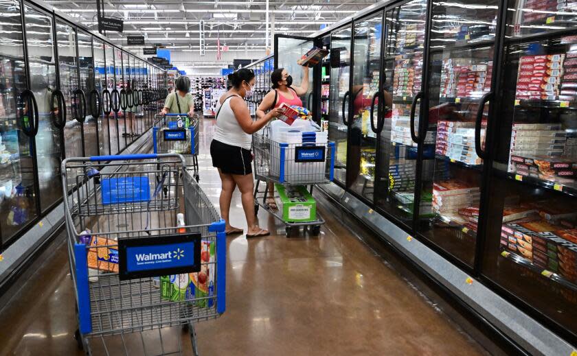 People shop for frozen food at a store in Rosemead, California on June 28, 2022. - Americans' feelings about the economy slumped further in June after falling sharply the month before amid concerns over skyrocketing inflation, according to a survey released on June 28. Amid the fastest increase in US consumer prices in more than four decades, made worse by the war in Ukraine, the consumer confidence index fell to 98.7 from 103.2, its lowest level since February 2021, according to The Conference Board's monthly survey. (Photo by Frederic J. BROWN / AFP) (Photo by FREDERIC J. BROWN/AFP via Getty Images)