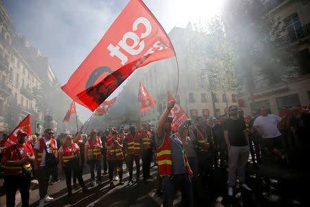 Workers wave CGT labour union flags with an image of revolutionary hero Ernesto "Che" Guevara during a demonstration against the French government’s reform plans in Marseille as part of a national day of protest, France, April 19, 2018. REUTERS/Jean-Paul Pelissier