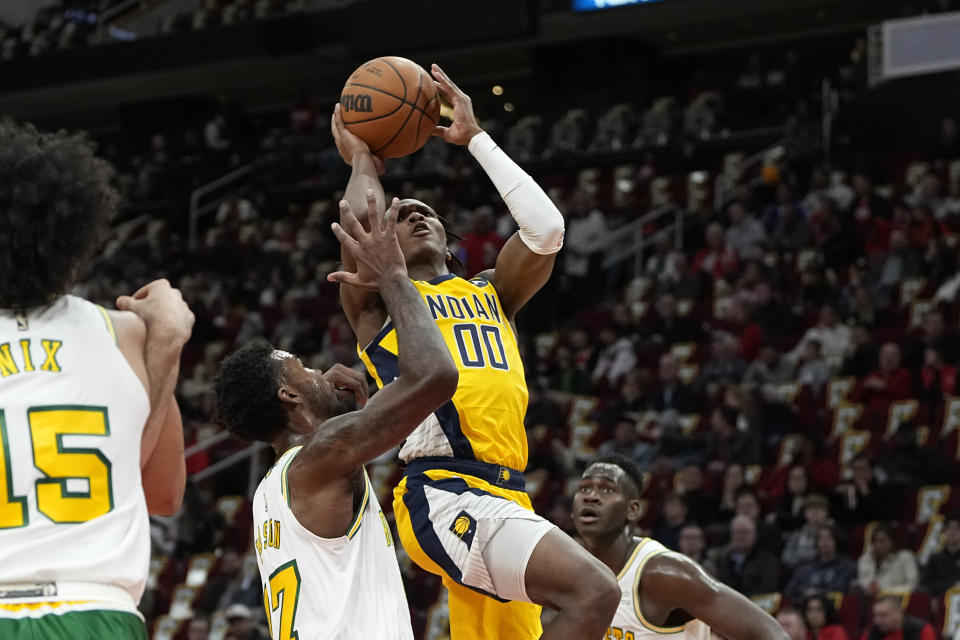 Indiana Pacers' Bennedict Mathurin (00) goes up for a shot as Houston Rockets' Tari Eason (17) defends during the first half of an NBA basketball game Friday, Nov. 18, 2022, in Houston. (AP Photo/David J. Phillip)