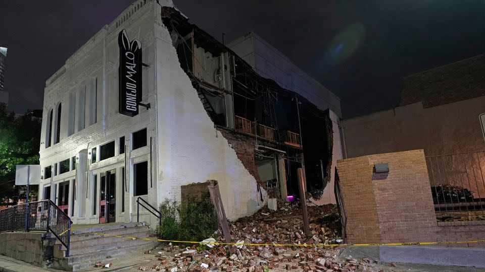 A damaged building is shown in the aftermath of a severe thunderstorm that passed through downtown Houston. - David J. Phillip/AP