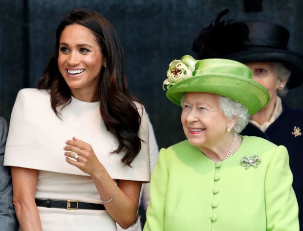 <p>June 2018 saw the Duchess of Sussex's first solo outing with the queen, for which she cut a high-fashion figure in this cream Givenchy outfit (designed by Clare Waight Keller, who also created Meghan’s extraordinary wedding gown.) The dress featured a sort of structured cape that entirely covered the shoulders and upper arms in a shell, while its skirt was a classic pencil shape. Meghan’s simple little pearl-and-diamond earrings were a gift from the queen.</p>