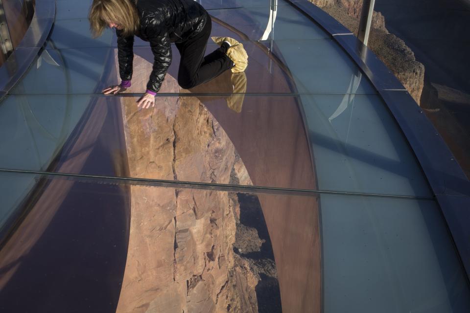 Susan Allen, who is afraid of heights, looks down on Skywalk on Janu. 17, 2018, at Grand Canyon West, Ariz.