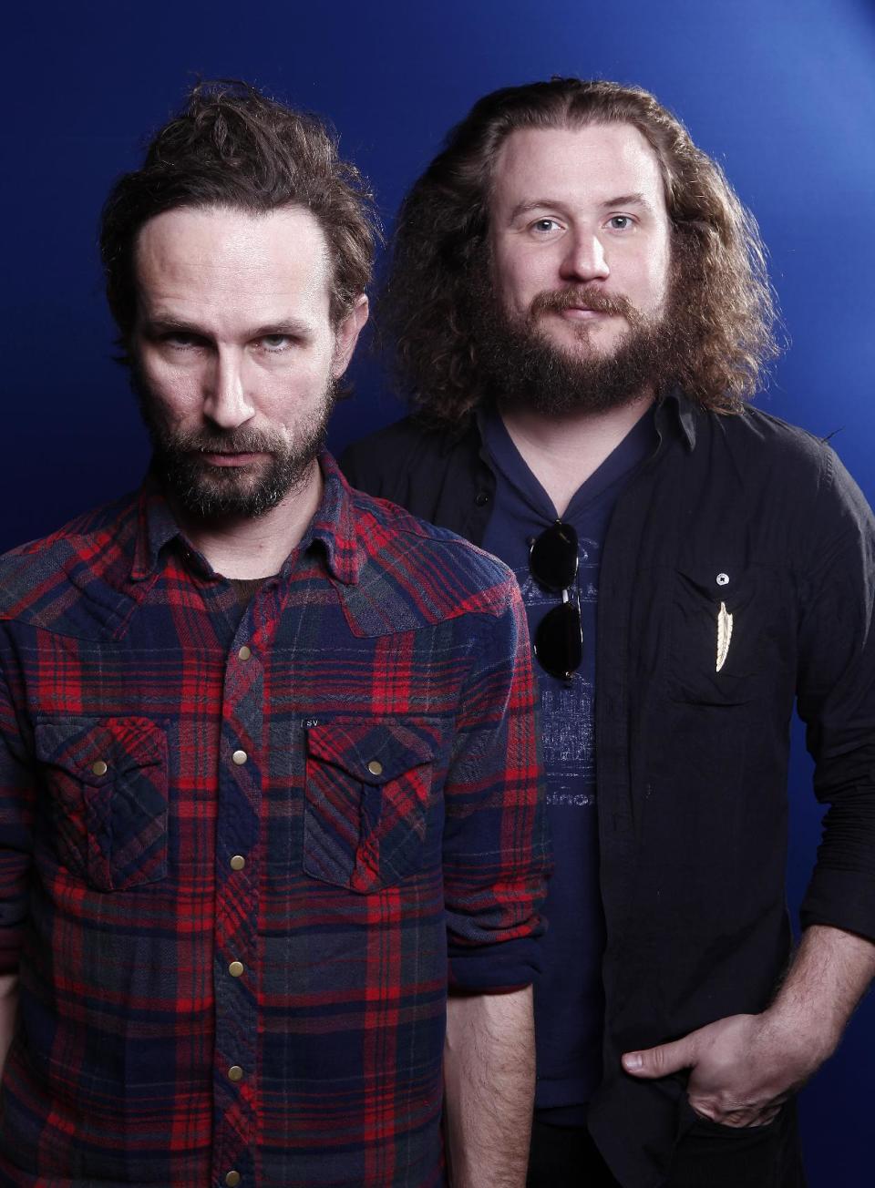 In this March 15, 2012 photo, musicians Will Johnson, left, and Yim Yames of the group "New Multitudes" pose for a portrait in New York. The group, which also includes Jay Farrar and Anders Parker, honors Woody Guthrie with new music based on his unfinished works. (AP Photo/Carlo Allegri)