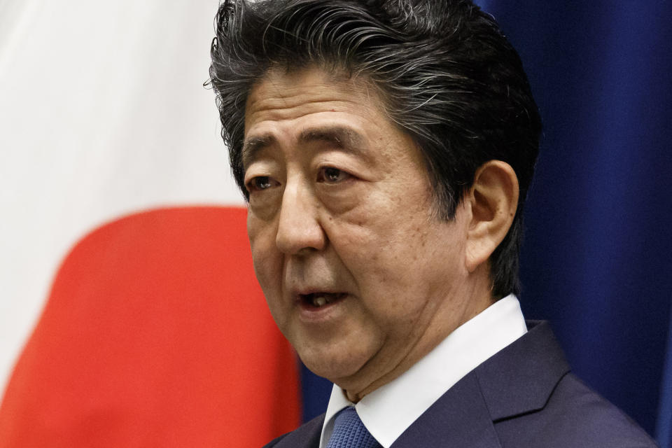 FILE - In this June 18, 2020, file photo, Japan's Prime Minister Shinzo Abe speaks during a press conference at the prime minister's official residence in Tokyo. The Abe government's Defense White Paper 2020 highlights what are potential Chinese and North Korean threats as Japan tries to further increase its defense capability. (Rodrigo Reyes Marin/Pool Photo via AP, File)