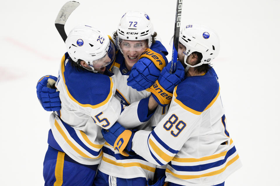 Buffalo Sabres center Tage Thompson (72) celebrates his overtime goal with defenseman Owen Power (25) and right wing Alex Tuch (89) in the team's NHL hockey game against the Washington Capitals, Tuesday, Jan. 3, 2023, in Washington. This was Thompson's third goal of the night. The Sabres won 5-4. (AP Photo/Nick Wass)