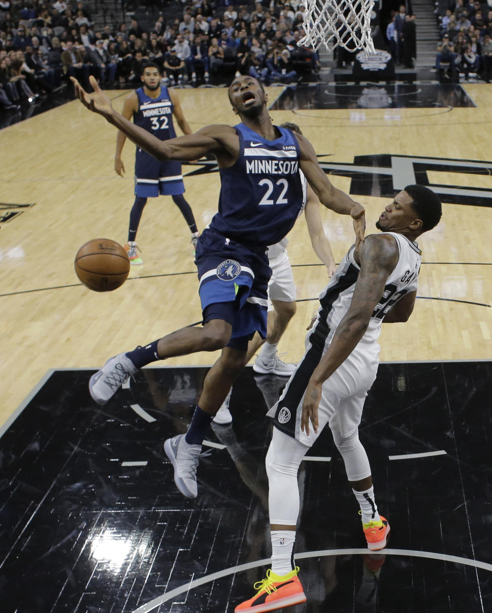 Minnesota Timberwolves guard Andrew Wiggins (22) is blocked by San Antonio Spurs forward Rudy Gay (22) as he tries to score during the first half of an NBA basketball game, Wednesday, Oct. 17, 2018, in San Antonio. (AP Photo/Eric Gay)