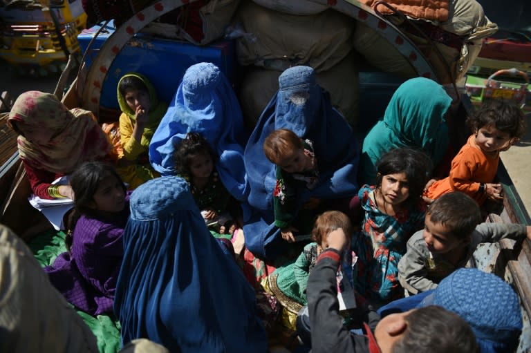 Afghan refugee families sit in a truck as they return from Pakistan to the United Nations High Commissioner for Refugees (UNHCR) camp on the outskirts of Kabul on September 27, 2016