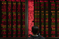 An investor monitors stock prices at a brokerage in Beijing on Thursday, Dec. 12, 2019. Asian shares are mixed after a wobbly day on Wall Street following the Federal Reserve announcement that it would leave interest rates unchanged. Japan's benchmark Nikkei 225, South Korea's Kospi and Hong Kong's Hang Seng rose in early Thursday trading. (AP Photo/Ng Han Guan)