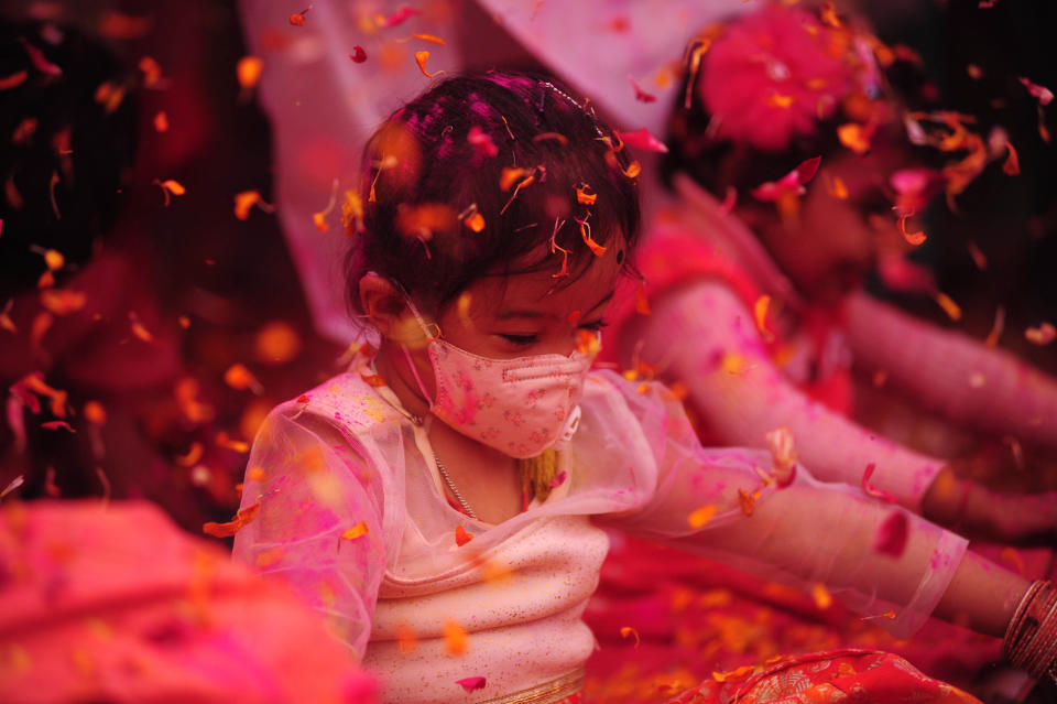 A girl in a face mask takes part in an event to celebrate the Hindu festival of Holi for the children with cerebral palsy , organised by The Trishla Foundation , in Allahabad on March 6,2020. (Photo by Ritesh Shukla/NurPhoto via Getty Images)