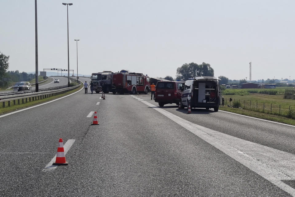 Emergency crews work at the site of a bus accident near Slavonski Brod, Croatia, Sunday, July 25, 2021. A bus swerved off a highway and crashed in Croatia early Sunday, killing 10 people and injuring at least 30 others, police said. (AP Photo/Luka Safundzic, SBonline)