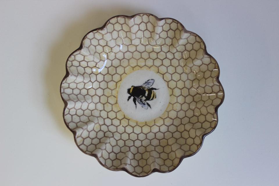A scalloped bee bowl from Wanderlust Ceramics in East Greenwich.