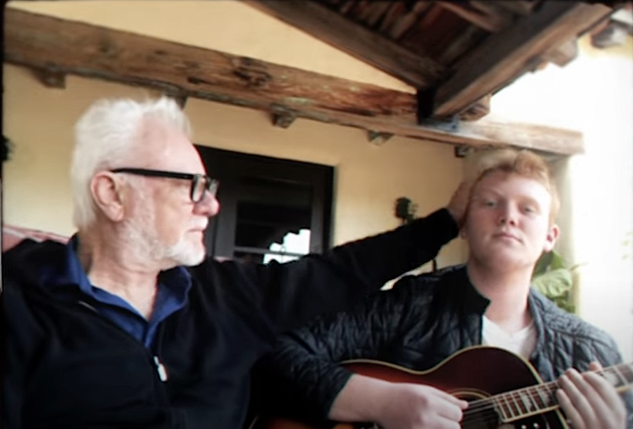 A screenshot of actor Malcolm McDowell with son Beckett Rex, from Rex's 2022 music video for 
