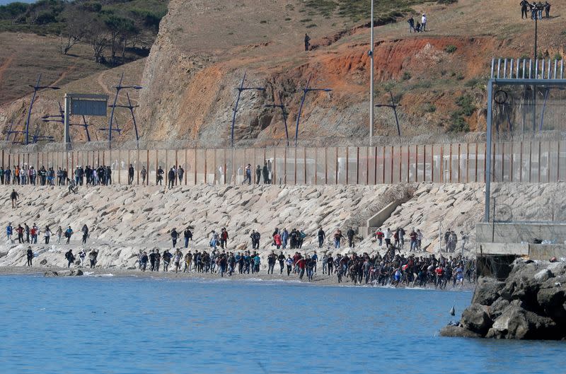 FILE PHOTO: Thousands of migrants cross the Spanish-Moroccan border