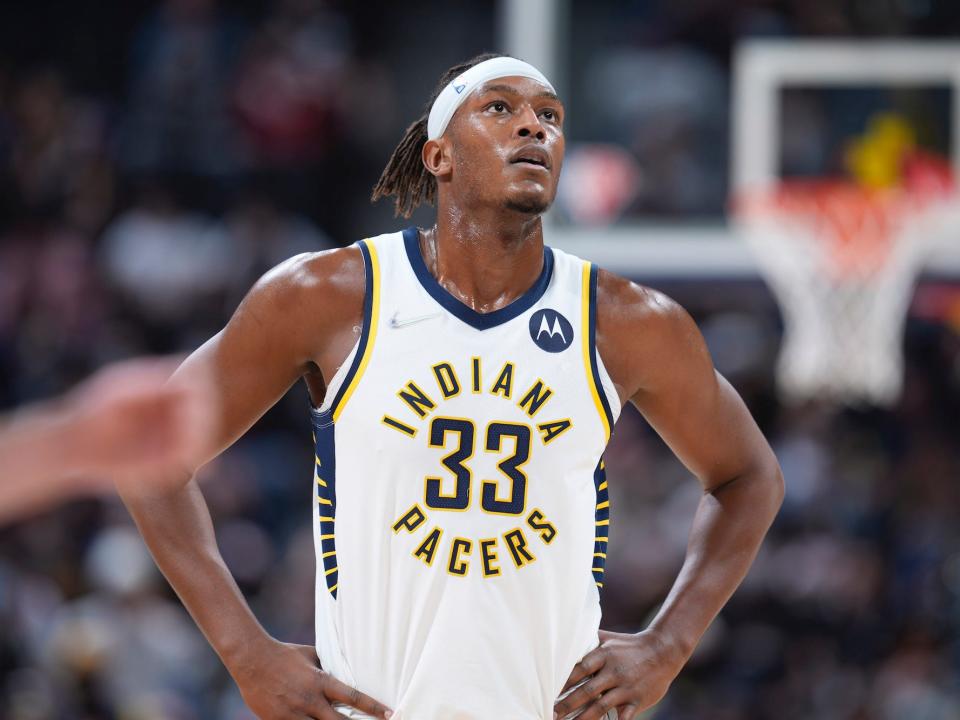 Myles Turner puts his hands on his hips and looks up during a game.