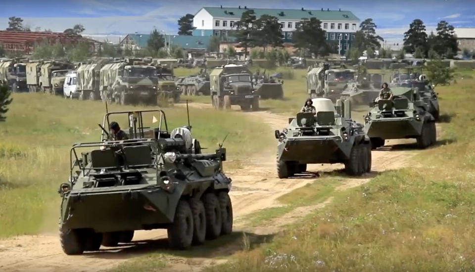 <em>Russian armoured personnel carriers roll during the military exercises (AP)</em>