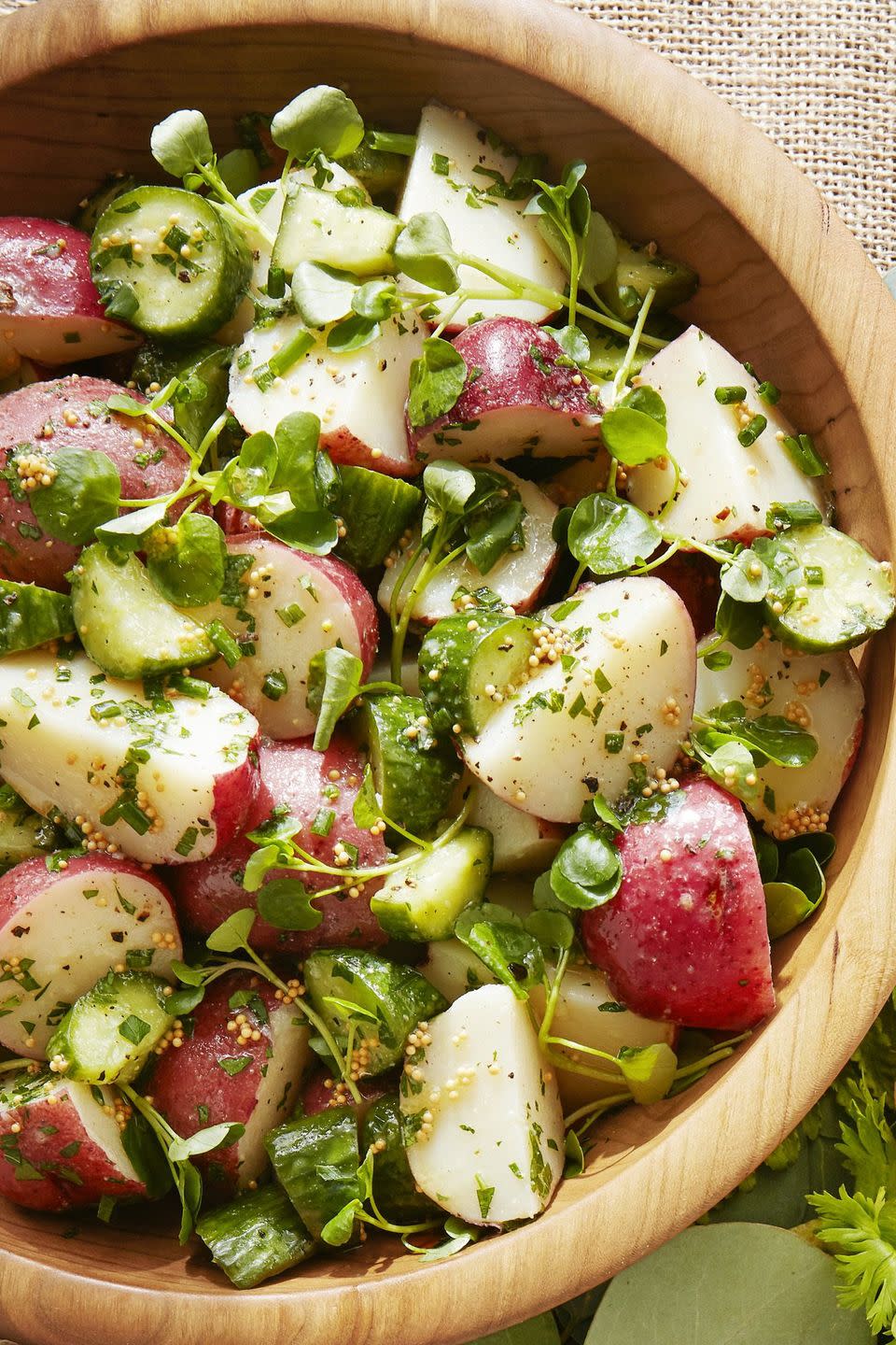 tangy potato salad in a wooden serving bowl