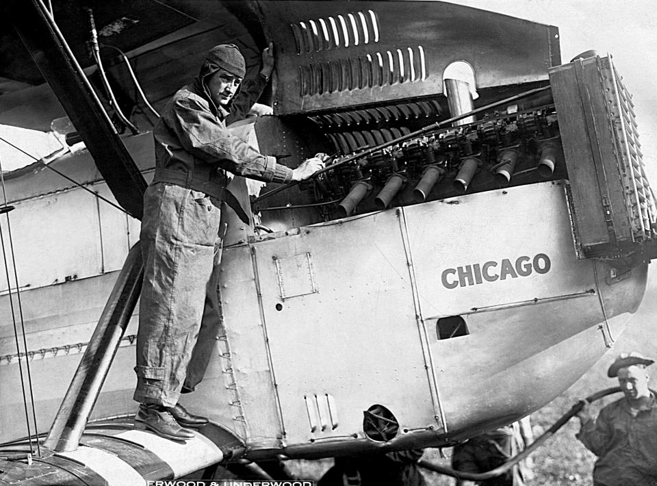 Lt. Lowell H. Smith checks the engine of the Douglas World Cruiser Number 2 