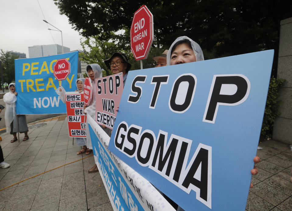 In this July 24, 2019, photo, protesters stage a rally demanding the abolition of the General Security of Military Information Agreement, or GSOMIA, an intelligence-sharing agreement between South Korea and Japan as they wait for the arrival of U.S. National Security Advisor John Bolton in front of the Foreign Ministry in Seoul, South Korea. South Korea has threatened to end the military intelligence sharing agreement with Japan as their tensions escalate over export controls. (AP Photo/Ahn Young-joon)