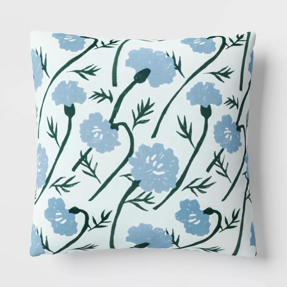 Floral patterned throw pillow with blue flower designs for home decor