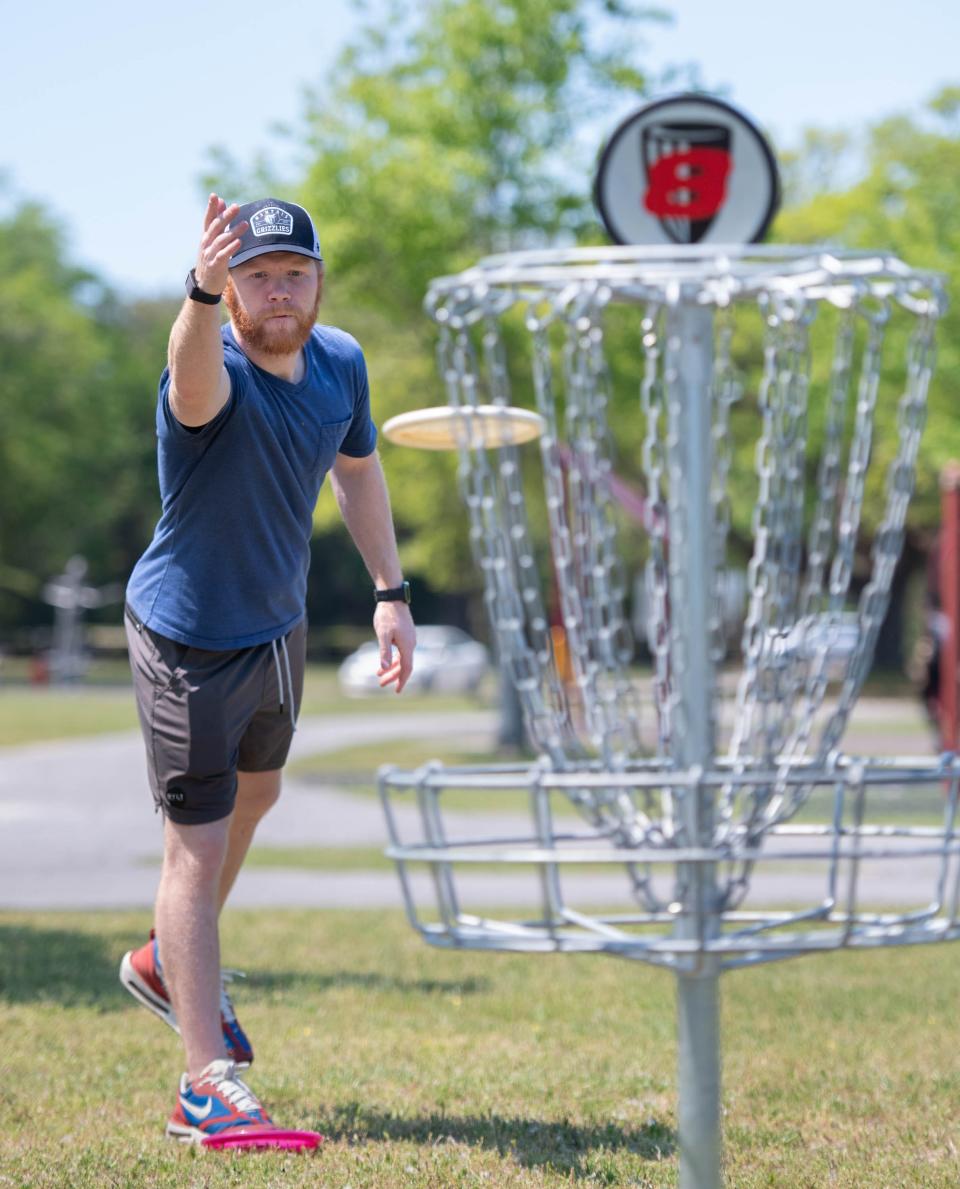 Chris Hill putts at the new Lexington Terrace Disc Golf Course in Warrington on Thursday, April 4, 2024.