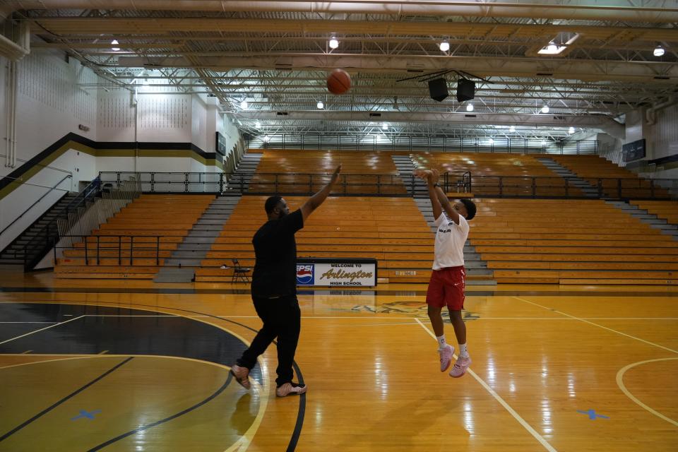 Gavin Collins, 11, takes a three-point basketball shot while practicing with his father Quinton Collins, 32, on Thursday, June 9, 2022, at Thrival Indy Academy in Indianapolis. Collins is being celebrated for taking an active role in his son's life, despite not having full custody. He is inspired to be the father figure he didn't have in his life growing up, and he often practices basketball with his son.