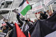 People hold placards and Palestinian flags as they march in solidarity with the Palestinian people amid the ongoing conflict with Israel, during a demonstration in London, Saturday, May 15, 2021. (AP Photo/Alberto Pezzali)