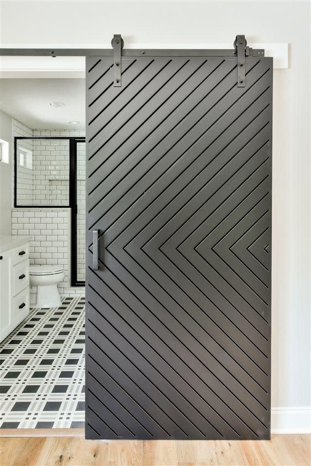 <p>You bet that's a barn door leading to a master bathroom with statement tile floors.</p>