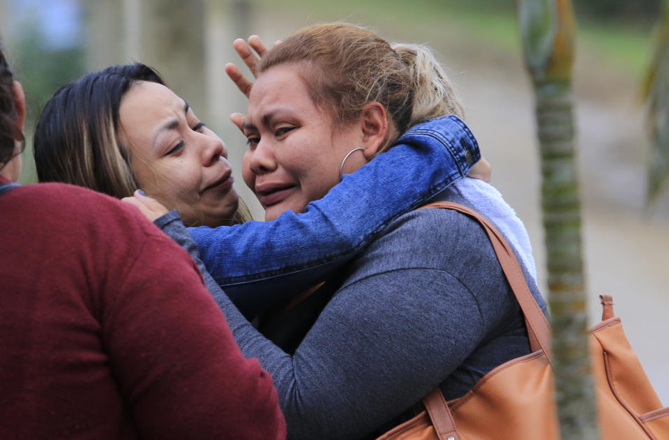 Family members cry as they wait for news from their imprisoned relatives, outside the Tela prison where at least 18 inmates were killed during a riot on Friday, in Tela, Honduras, Saturday, Dec. 21, 2019. The riot came several days after Honduras declared a state of emergency in its prison system. (AP Photo/Delmer Martinez)